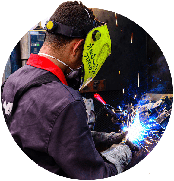 a welder working on a piece of metal with WSE welding equipment